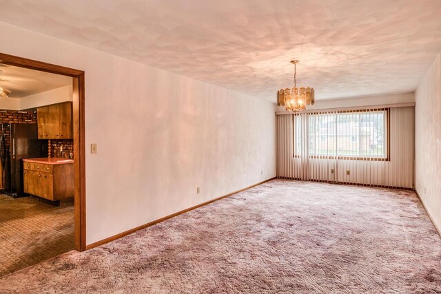 275 Pawnee St, Battle Creek, MI 49014 - carpeted spare room featuring a chandelier and baseboards