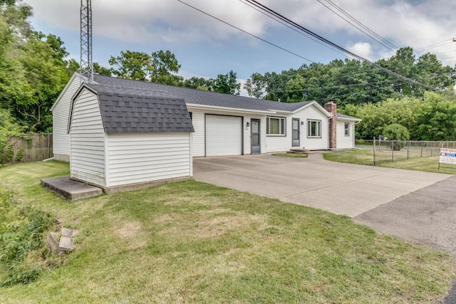 275 Pawnee St, Battle Creek, MI 49014 - view of front facade featuring a shingled roof, a garage, driveway, and a storage unit