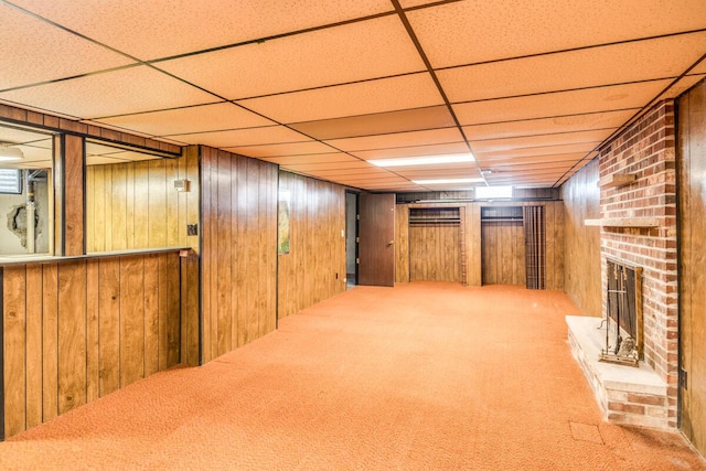 275 Pawnee St, Battle Creek, MI 49014 - finished below grade area featuring a brick fireplace, carpet, wood walls, and a drop ceiling