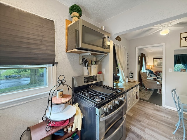 20115 Pelkey St, Detroit, MI 48205 - kitchen featuring stainless steel appliances, a textured wall, a textured ceiling, light wood-type flooring, and a ceiling fan