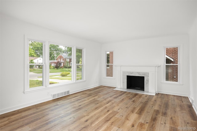 807 Barrington Rd, Grosse Pointe Park, MI 48230 - unfurnished living room with wood finished floors and a high end fireplace