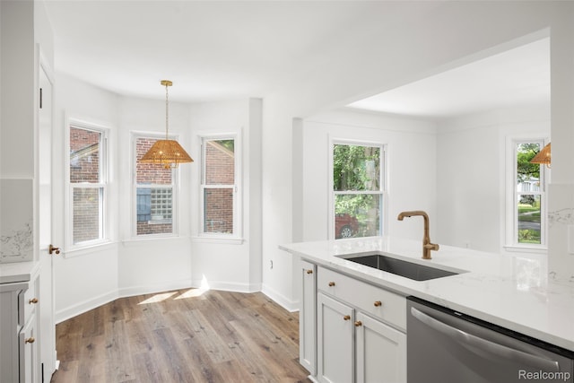 807 Barrington Rd, Grosse Pointe Park, MI 48230 - kitchen featuring dishwasher, light wood-style floors, white cabinetry, decorative light fixtures, and light stone counters