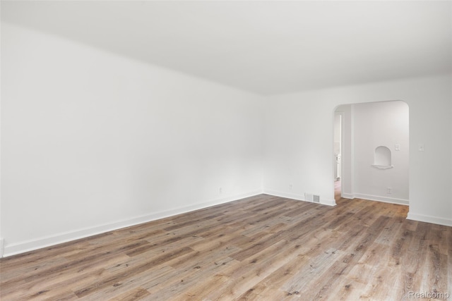 807 Barrington Rd, Grosse Pointe Park, MI 48230 - spare room with arched walkways and wood finished floors