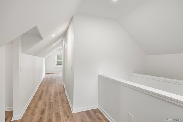 807 Barrington Rd, Grosse Pointe Park, MI 48230 - hallway with vaulted ceiling, light wood-style floors, and an upstairs landing