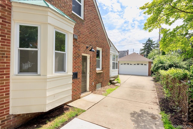 807 Barrington Rd, Grosse Pointe Park, MI 48230 - view of property exterior featuring brick siding, a garage, and an outbuilding