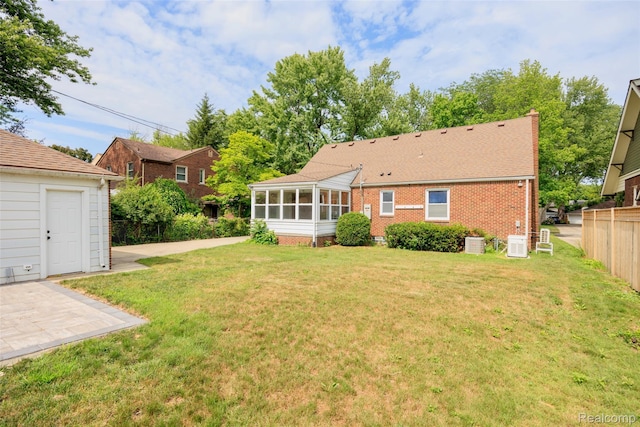 807 Barrington Rd, Grosse Pointe Park, MI 48230 - rear view of property featuring a sunroom and brick siding