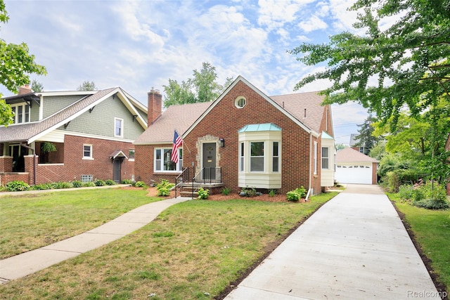 807 Barrington Rd, Grosse Pointe Park, MI 48230 - view of front facade with a chimney, brick siding, a detached garage, a front lawn, and an outdoor structure
