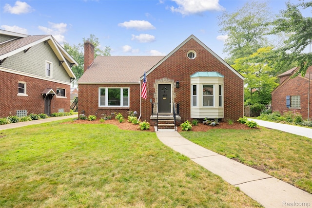807 Barrington Rd, Grosse Pointe Park, MI 48230 - view of front of home featuring brick siding, a front yard, and a chimney