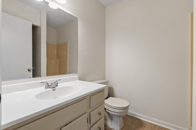 3745 Cedaridge Rd, Kalamazoo, MI 49008 - full bathroom with vanity, a shower, and wood finished floors