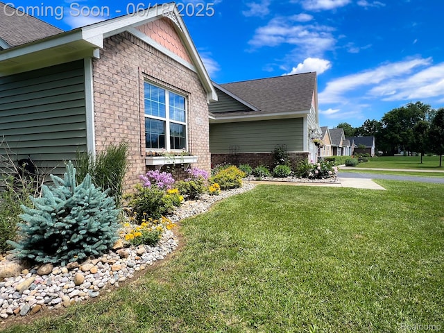 11236 Chyna Run, Davisburg, MI 48350 - view of side of property featuring brick siding, a yard, and a shingled roof