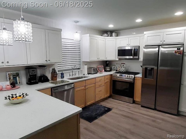11236 Chyna Run, Davisburg, MI 48350 - kitchen with appliances with stainless steel finishes, light wood-style floors, light countertops, decorative light fixtures, and white cabinets