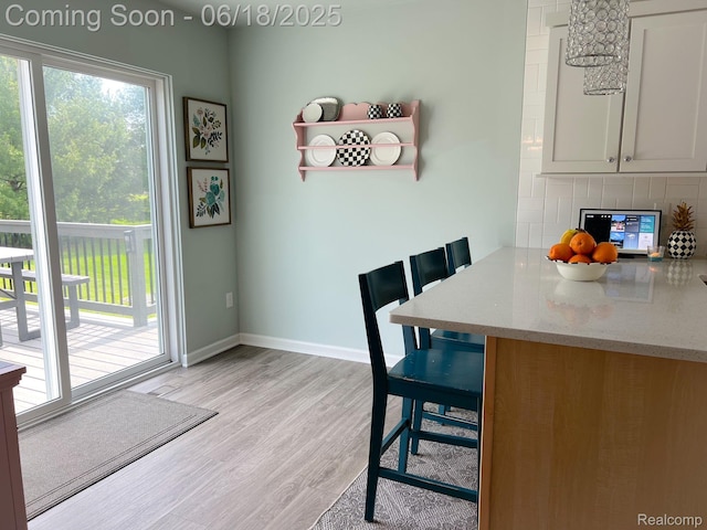 11236 Chyna Run, Davisburg, MI 48350 - dining room featuring light wood-type flooring and baseboards