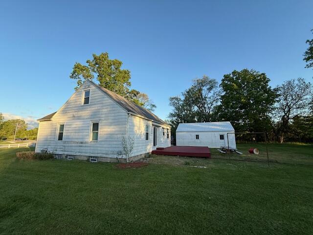 6185 Wing Ave SE, Grand Rapids, MI 49512 - rear view of house featuring a wooden deck and a yard
