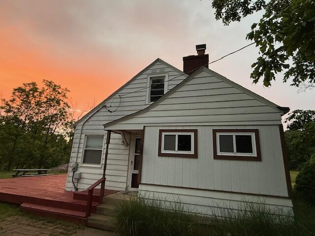 6185 Wing Ave SE, Grand Rapids, MI 49512 - rear view of house featuring a wooden deck and a chimney