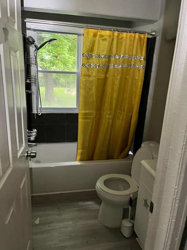 8627 Stout St, Detroit, MI 48228 - bathroom with wood finished floors and shower / bath combo with shower curtain