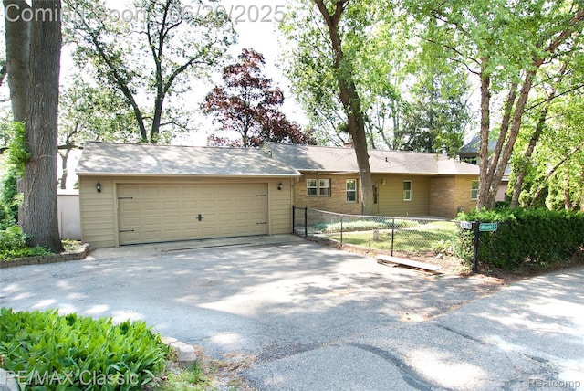 1861 Ladd Rd, Wolverine Lake, MI 48390 - ranch-style house featuring a garage and asphalt driveway