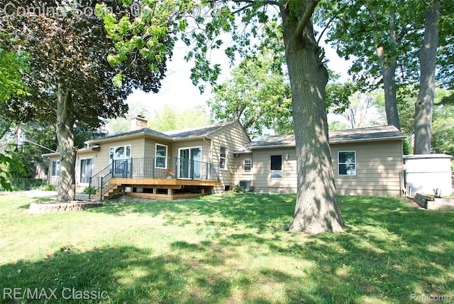 1861 Ladd Rd, Wolverine Lake, MI 48390 - rear view of house with a wooden deck, a chimney, and a yard