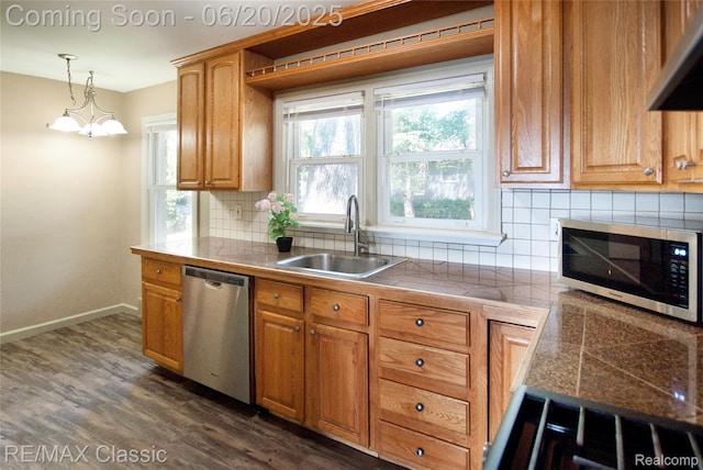 1861 Ladd Rd, Wolverine Lake, MI 48390 - kitchen featuring appliances with stainless steel finishes, backsplash, decorative light fixtures, dark wood-style floors, and under cabinet range hood
