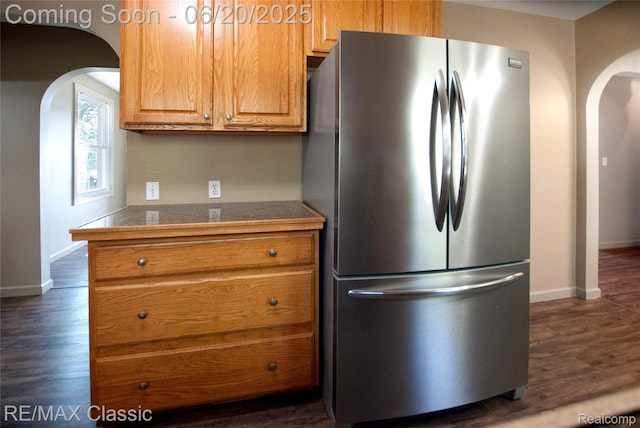 1861 Ladd Rd, Wolverine Lake, MI 48390 - kitchen with freestanding refrigerator, arched walkways, dark wood-type flooring, and brown cabinetry