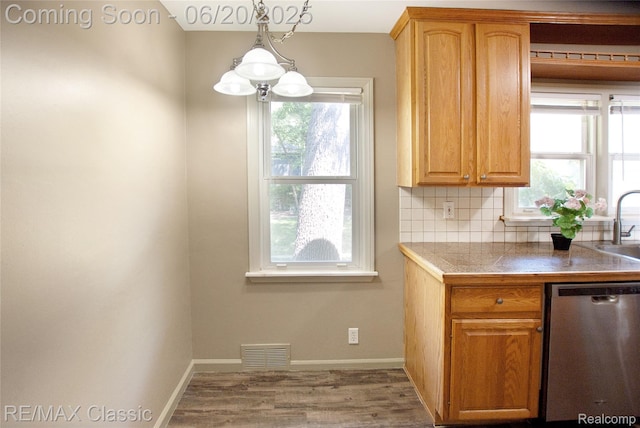 1861 Ladd Rd, Wolverine Lake, MI 48390 - kitchen with dishwasher, wood finished floors, tasteful backsplash, and decorative light fixtures