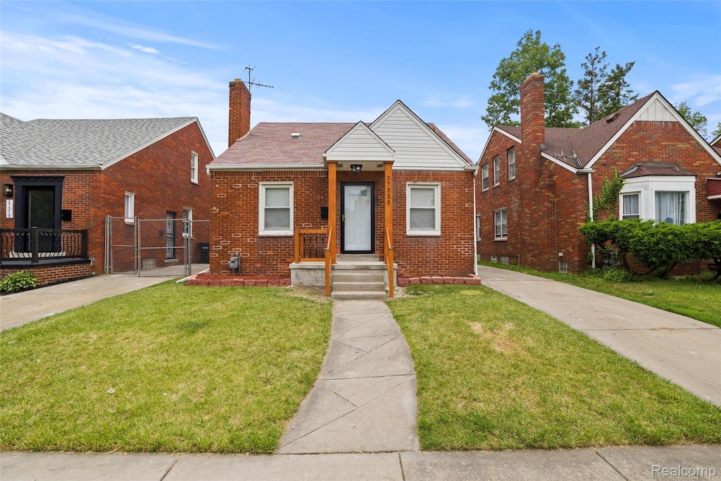 17325 Mansfield St, Detroit, MI 48235 - bungalow featuring a gate, brick siding, and a chimney