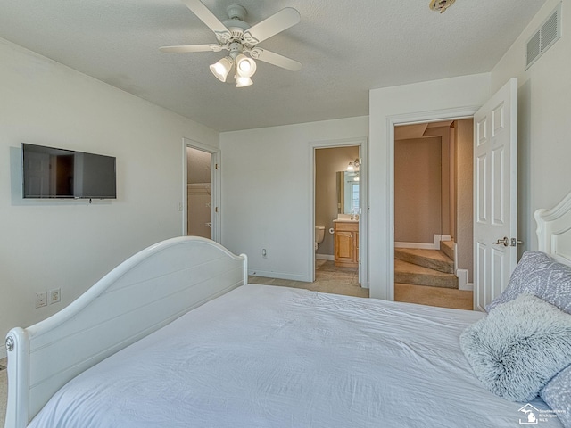 831 Saint James Park Ave, Monroe, MI 48161 - bedroom with ceiling fan, ensuite bathroom, a textured ceiling, and light carpet