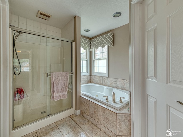 831 Saint James Park Ave, Monroe, MI 48161 - bathroom with a jetted tub, a shower stall, tile patterned floors, and a textured ceiling