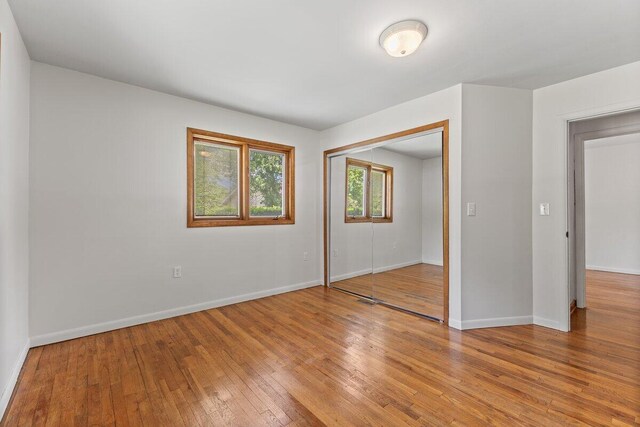 1228 Orchid St, Waterford, MI 48328 - unfurnished bedroom with light wood-style floors and a closet