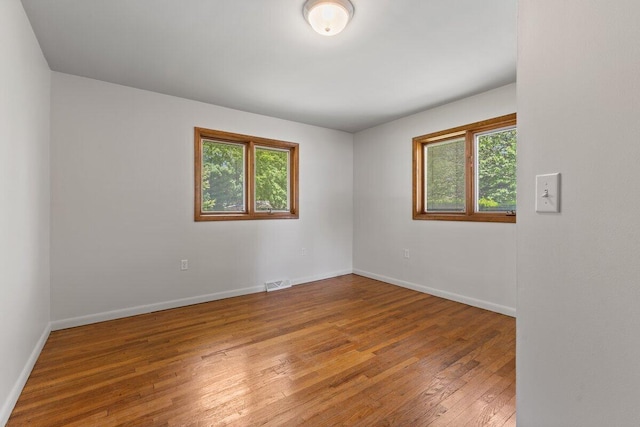 1228 Orchid St, Waterford, MI 48328 - empty room with wood-type flooring and baseboards