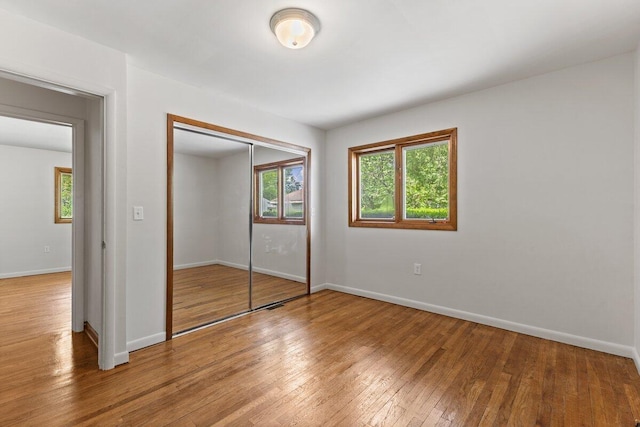 1228 Orchid St, Waterford, MI 48328 - unfurnished bedroom with light wood finished floors and a closet