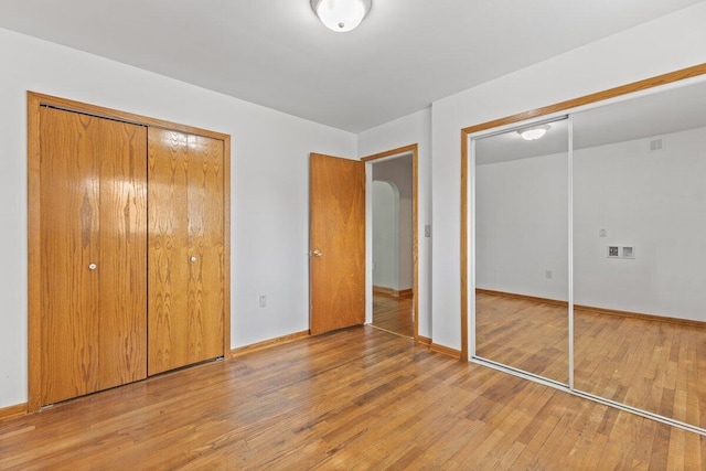 1228 Orchid St, Waterford, MI 48328 - unfurnished bedroom featuring wood finished floors and baseboards