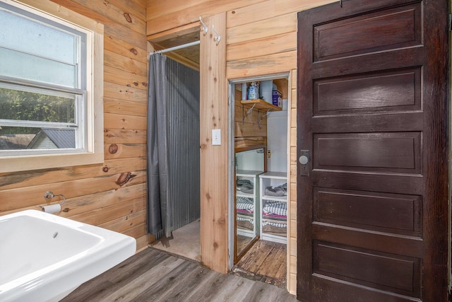 3833 S Baldwin Ave, Fremont, MI 49412 - full bath featuring wooden walls, wood finished floors, and a shower with shower curtain