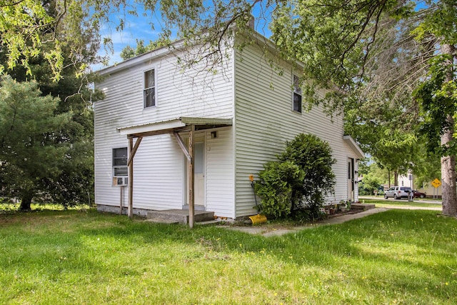 630 State St, Fremont, MI 49412 - view of side of property with a lawn