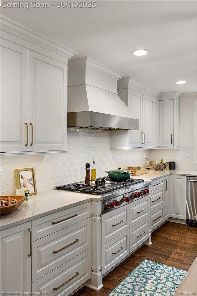 586 Fairfax St, Birmingham, MI 48009 - kitchen with wall chimney exhaust hood, white cabinets, appliances with stainless steel finishes, and light countertops