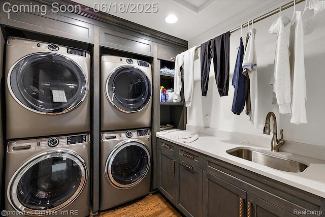 586 Fairfax St, Birmingham, MI 48009 - laundry area with separate washer and dryer, stacked washer and clothes dryer, crown molding, cabinet space, and wood finished floors