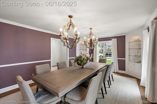 586 Fairfax St, Birmingham, MI 48009 - dining space with a chandelier, wood finished floors, built in features, and ornamental molding