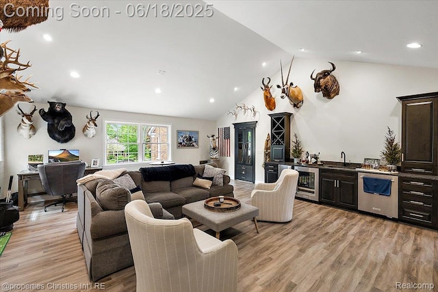 586 Fairfax St, Birmingham, MI 48009 - living room featuring bar with sink, beverage cooler, light wood-style floors, high vaulted ceiling, and recessed lighting
