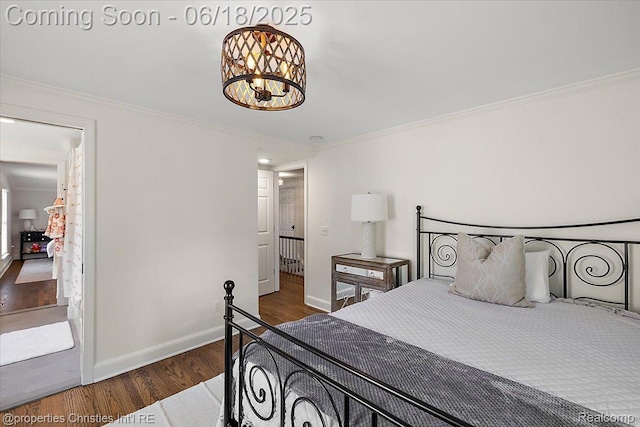 586 Fairfax St, Birmingham, MI 48009 - bedroom featuring wood finished floors, ornamental molding, and a chandelier
