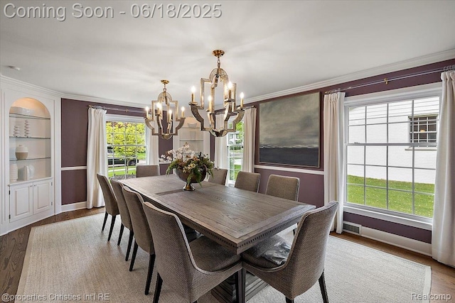 586 Fairfax St, Birmingham, MI 48009 - dining room with a chandelier, built in shelves, wood finished floors, and ornamental molding