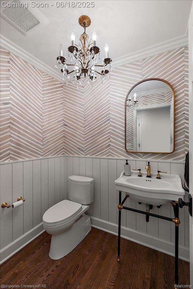 586 Fairfax St, Birmingham, MI 48009 - bathroom with wallpapered walls, wood finished floors, a chandelier, wainscoting, and crown molding