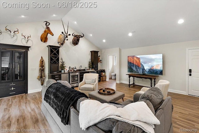 586 Fairfax St, Birmingham, MI 48009 - living area featuring wine cooler, bar with sink, vaulted ceiling, wood finished floors, and recessed lighting