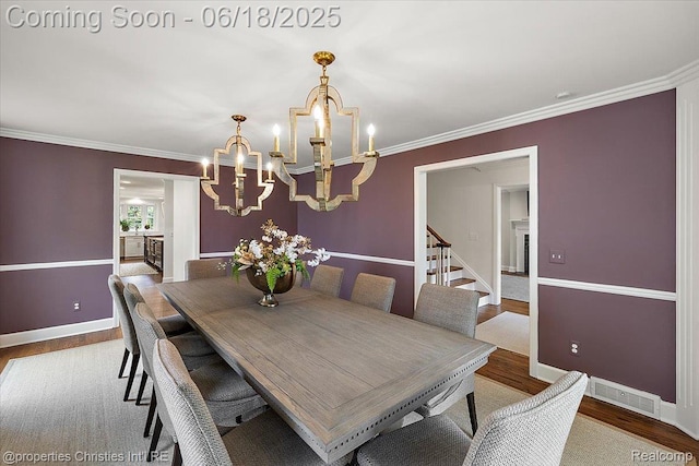 586 Fairfax St, Birmingham, MI 48009 - dining room featuring a chandelier, wood finished floors, crown molding, and stairs