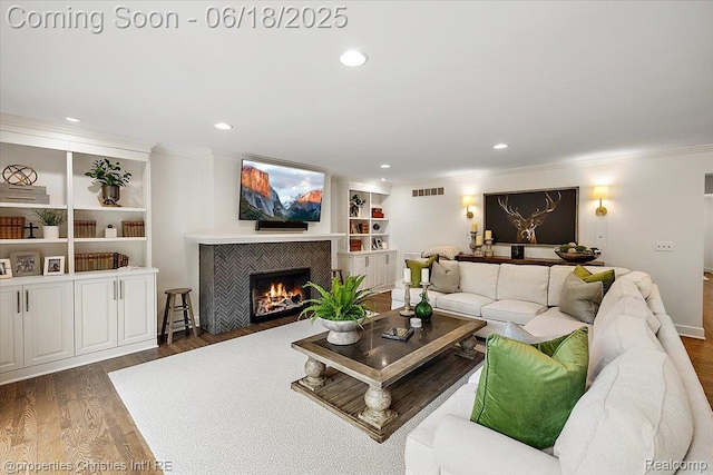 586 Fairfax St, Birmingham, MI 48009 - living room featuring ornamental molding, wood finished floors, a fireplace, recessed lighting, and built in shelves