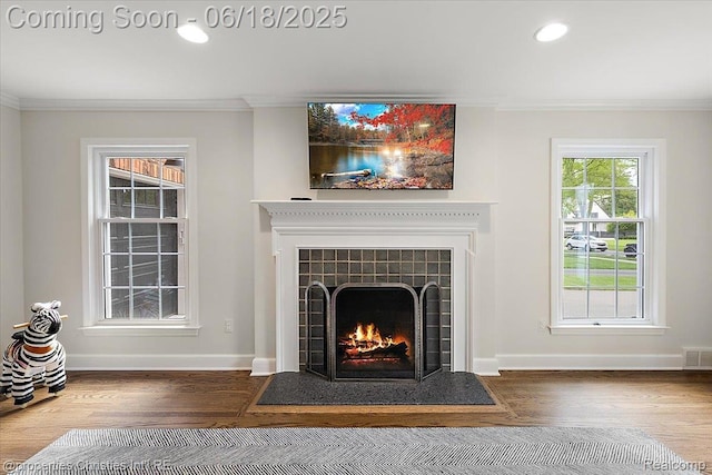 586 Fairfax St, Birmingham, MI 48009 - detailed view of ornamental molding, wood finished floors, a tiled fireplace, and recessed lighting