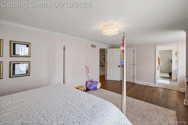 586 Fairfax St, Birmingham, MI 48009 - bedroom featuring wood finished floors, ornamental molding, a chandelier, and a closet