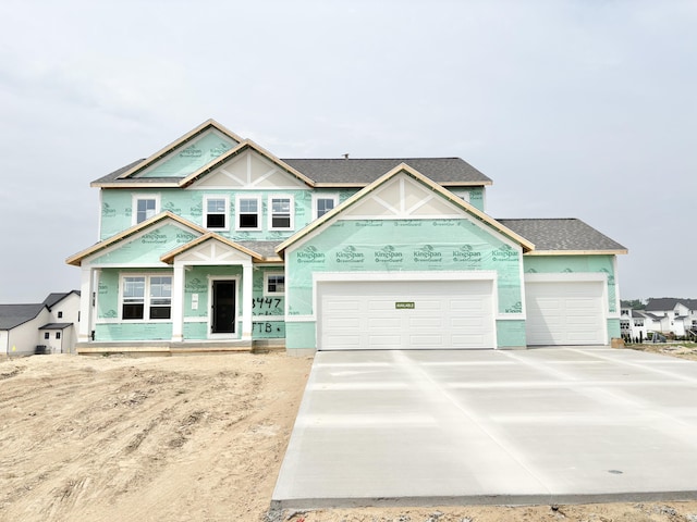 3447 Conrail Dr SW, Byron Center, MI 49315 - property in mid-construction with concrete driveway, a garage, a porch, and a shingled roof