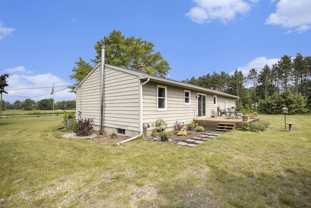 1602 Mccann Rd, Hastings, MI 49058 - back of property featuring a deck, a lawn, and a chimney