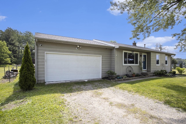 1602 Mccann Rd, Hastings, MI 49058 - ranch-style home with dirt driveway, a front lawn, and a garage