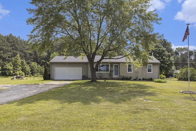 1602 Mccann Rd, Hastings, MI 49058 - view of front of home with driveway, an attached garage, and a front lawn