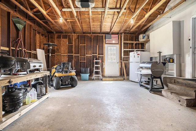 1602 Mccann Rd, Hastings, MI 49058 - basement with freestanding refrigerator and a garage